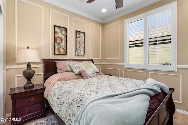 bedroom featuring ceiling fan, hardwood / wood-style floors, and ornamental molding