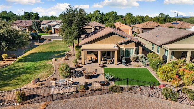 back of property featuring a lawn and a patio area