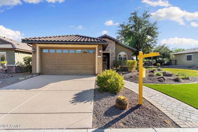 view of front of property featuring a garage and a front lawn