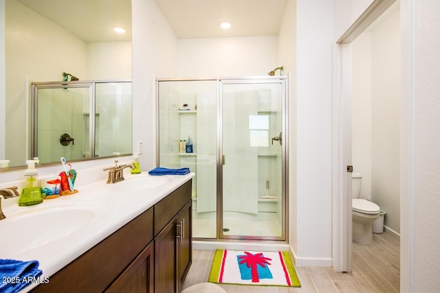 bathroom featuring vanity, toilet, and walk in shower