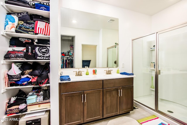 bathroom with tile patterned floors, vanity, and walk in shower