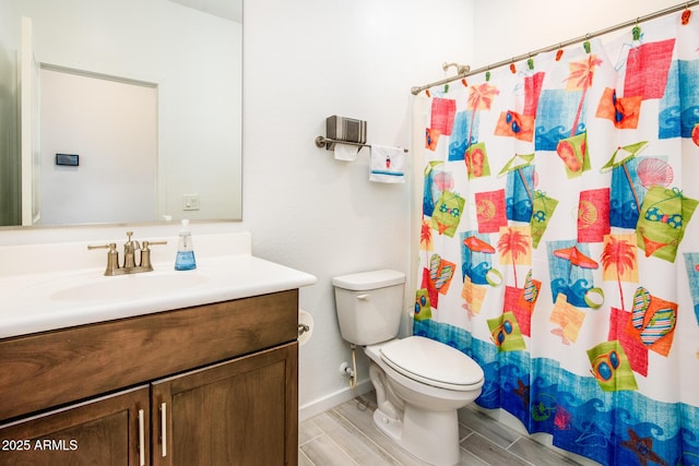 bathroom with walk in shower, vanity, and toilet