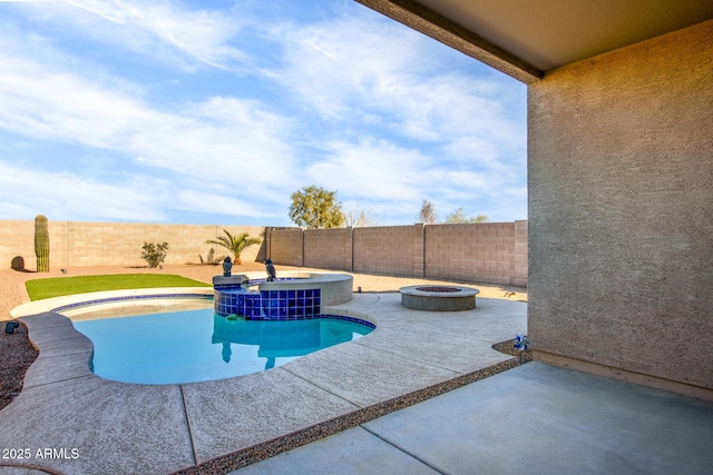 view of swimming pool with an in ground hot tub, a patio, and an outdoor fire pit