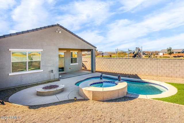 view of pool with a fire pit and an in ground hot tub