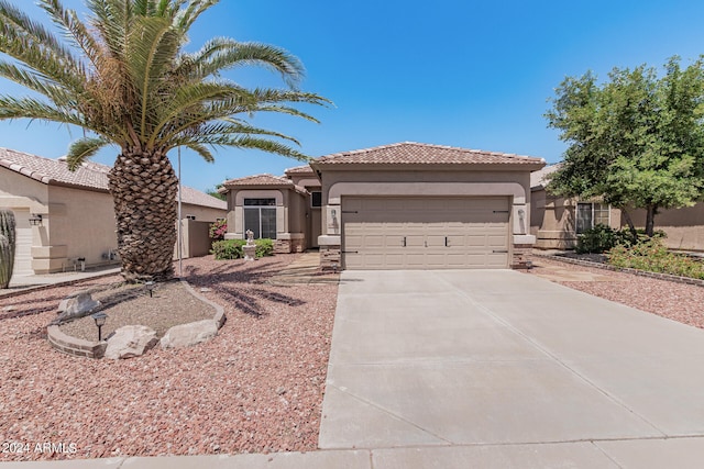 mediterranean / spanish-style house with a garage