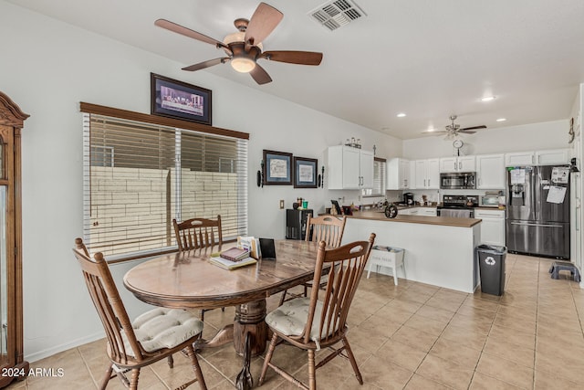 dining room with ceiling fan and light tile floors