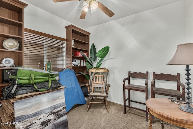 carpeted office space with ceiling fan