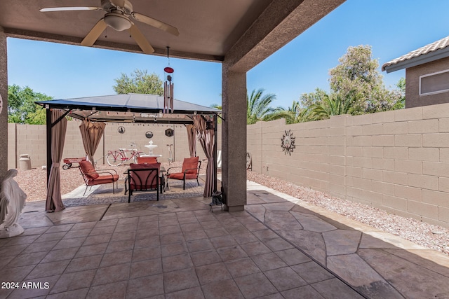 view of patio featuring ceiling fan and a gazebo