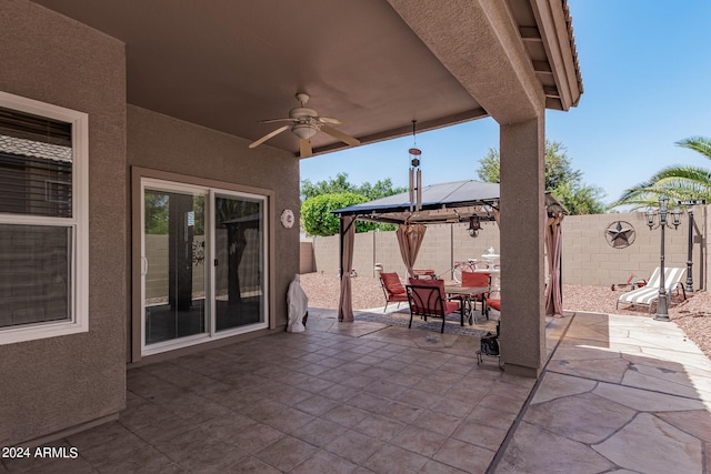 view of terrace with ceiling fan and a gazebo