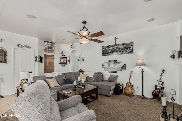 living room with tile floors and ceiling fan