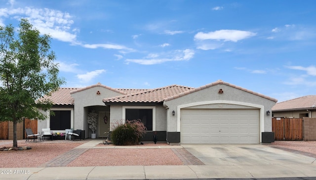 15019 W Banff Ln, Surprise, AZ 85379 - mediterranean / spanish home featuring a garage, concrete driveway, stucco siding, and a tiled roof