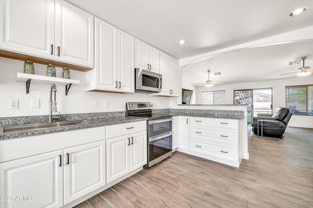 15019 W Banff Ln, Surprise, AZ 85379 - kitchen featuring stainless steel appliances, a ceiling fan, open shelves, a peninsula, and recessed lighting