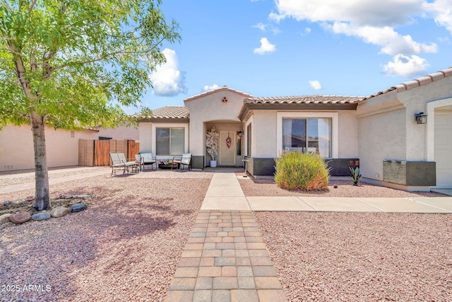 15019 W Banff Ln, Surprise, AZ 85379 - view of front of home featuring stucco siding, a tiled roof, and an outdoor hangout area