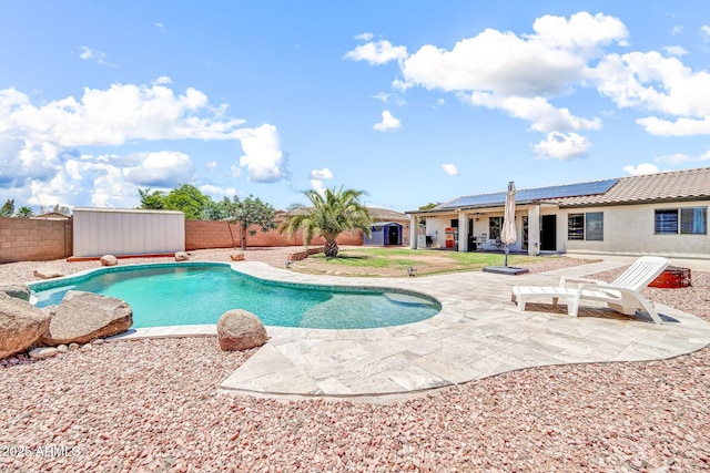 15019 W Banff Ln, Surprise, AZ 85379 - view of swimming pool featuring a fenced backyard, a patio, and a storage unit