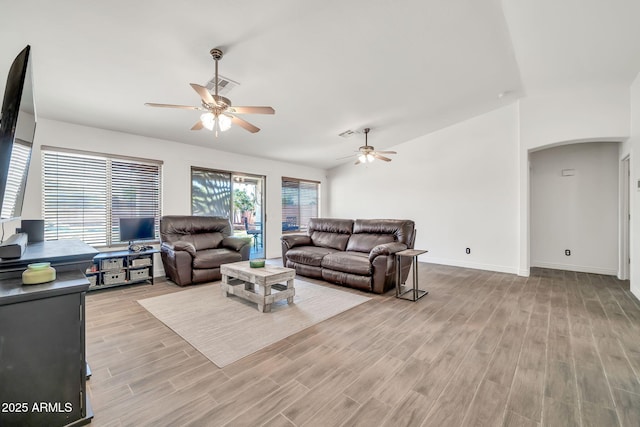 15019 W Banff Ln, Surprise, AZ 85379 - living area featuring a ceiling fan, arched walkways, light wood-style floors, and lofted ceiling