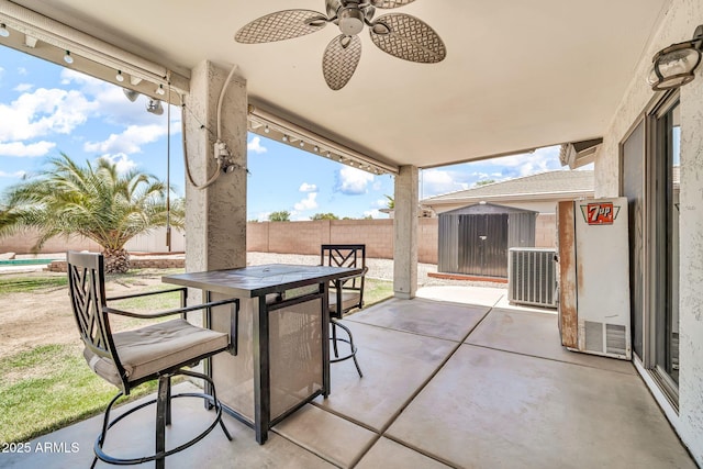 15019 W Banff Ln, Surprise, AZ 85379 - fenced backyard featuring a patio, a ceiling fan, and outdoor dining area