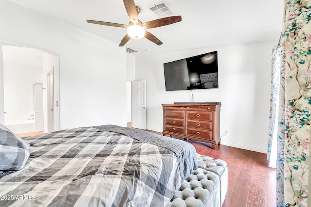 15019 W Banff Ln, Surprise, AZ 85379 - bedroom featuring arched walkways, wood finished floors, and ceiling fan