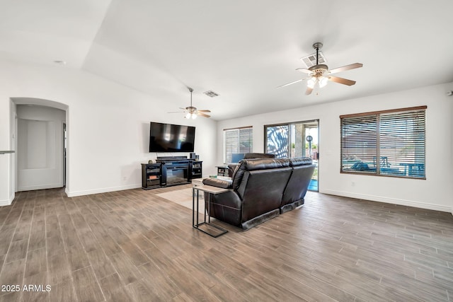 15019 W Banff Ln, Surprise, AZ 85379 - living area featuring ceiling fan, wood finished floors, arched walkways, and vaulted ceiling