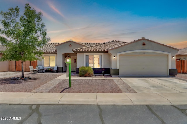 15019 W Banff Ln, Surprise, AZ 85379 - mediterranean / spanish home featuring stucco siding, a tiled roof, a garage, and concrete driveway