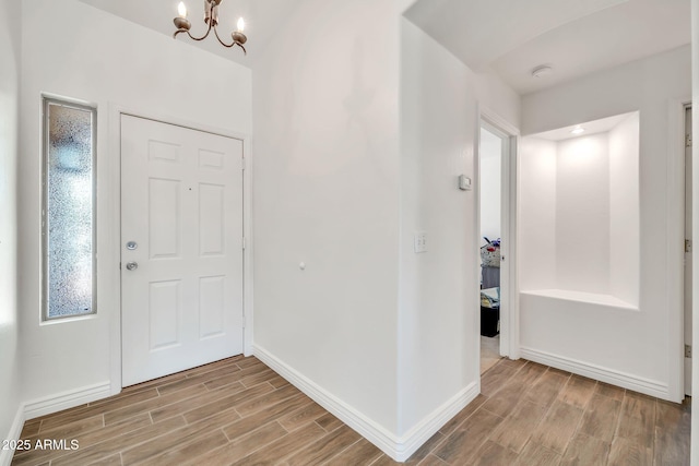 15019 W Banff Ln, Surprise, AZ 85379 - foyer entrance featuring wood finished floors and a chandelier