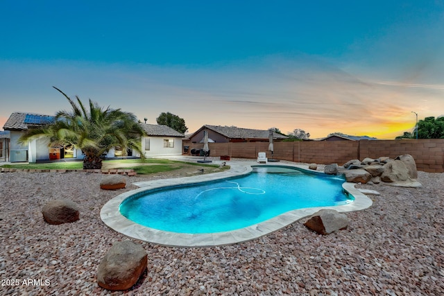 15019 W Banff Ln, Surprise, AZ 85379 - pool at dusk featuring a fenced backyard and a patio area