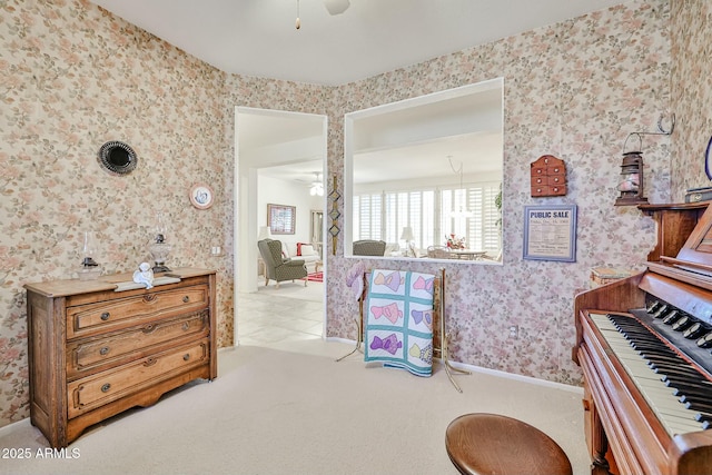 interior space featuring carpet flooring, ceiling fan, and wallpapered walls