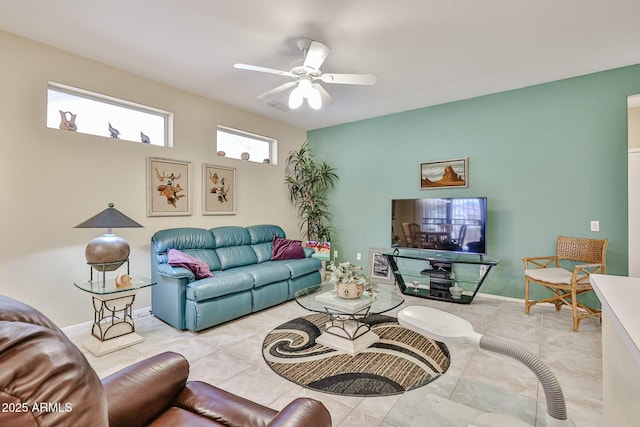 living room with ceiling fan and baseboards