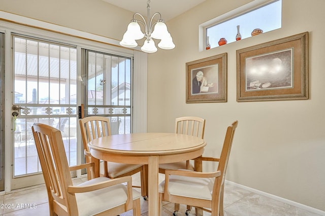 dining space with a chandelier, a wealth of natural light, and baseboards