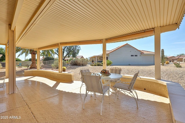 view of patio with outdoor dining space, a residential view, and fence