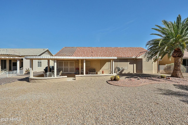 back of property featuring a patio area, stucco siding, a pergola, and a tiled roof