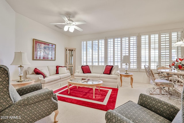 living room featuring carpet floors and a ceiling fan