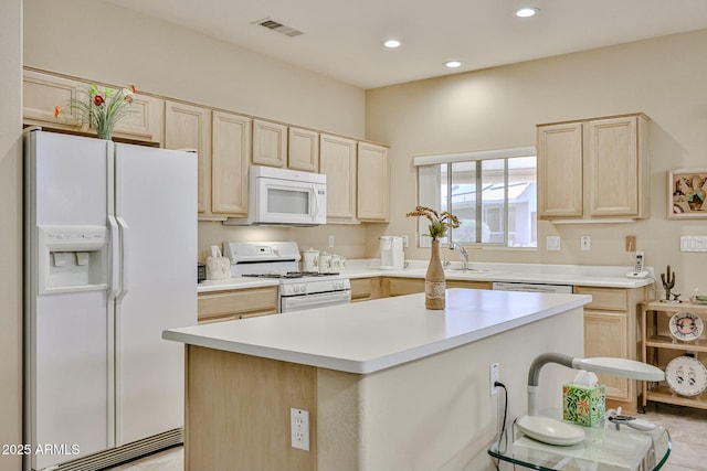 kitchen with light brown cabinetry, white appliances, and visible vents