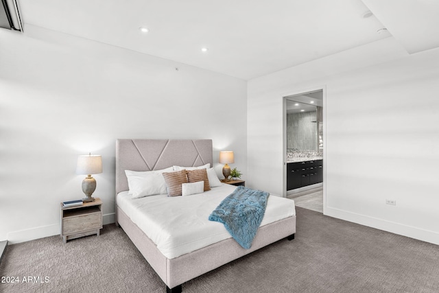 carpeted bedroom featuring ensuite bath