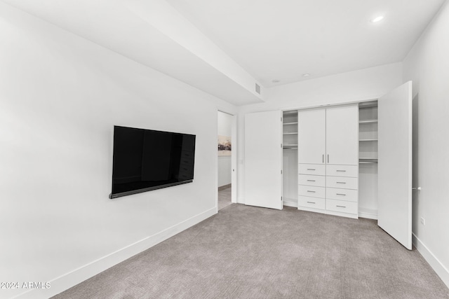 unfurnished bedroom featuring light carpet