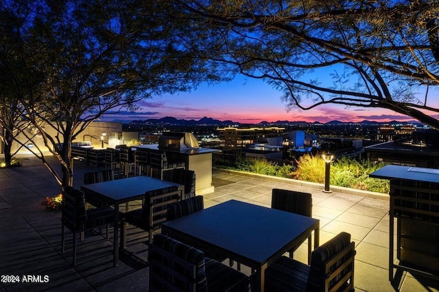 view of patio terrace at dusk