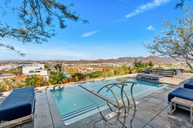 view of pool with a mountain view and a patio area