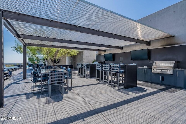 view of patio / terrace featuring grilling area and an outdoor bar