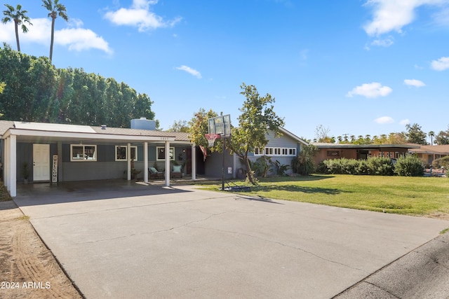 ranch-style home featuring a front lawn and a carport