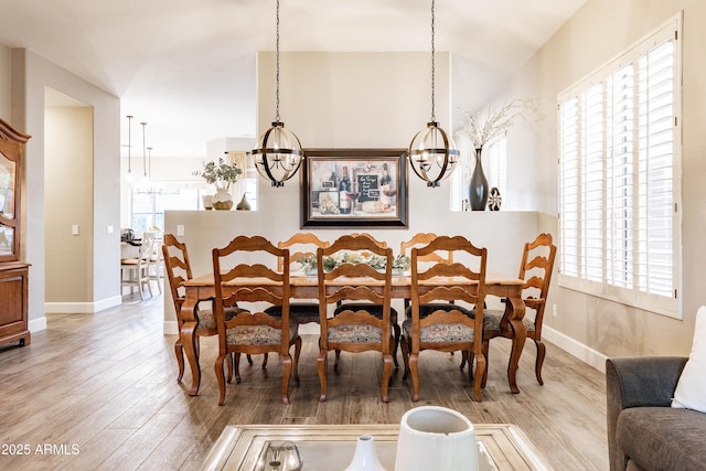 4422 E Spur Dr, Cave Creek, AZ 85331 - dining area featuring a chandelier, wood finished floors, and baseboards