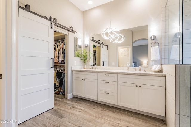 4422 E Spur Dr, Cave Creek, AZ 85331 - full bath featuring double vanity, wood finished floors, a walk in closet, and tiled shower