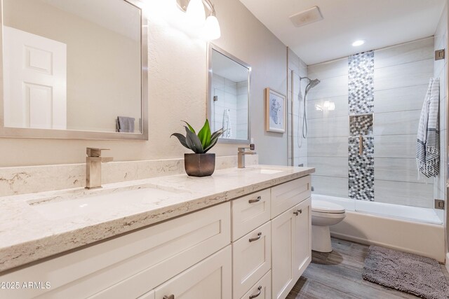4422 E Spur Dr, Cave Creek, AZ 85331 - full bathroom with toilet, double vanity, shower / bath combination, wood finished floors, and recessed lighting