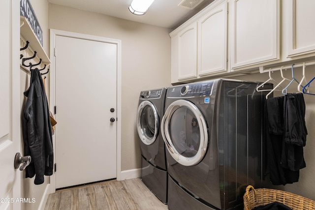 4422 E Spur Dr, Cave Creek, AZ 85331 - laundry room featuring washing machine and dryer, cabinet space, light wood-style flooring, and baseboards