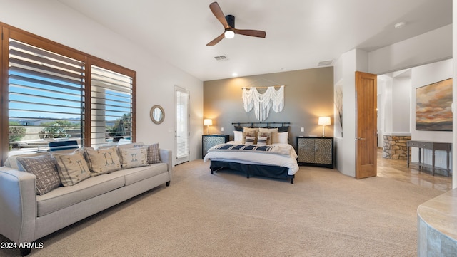 bedroom with ceiling fan and light colored carpet