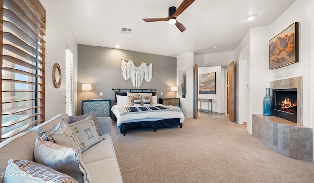 bedroom with ceiling fan and light carpet