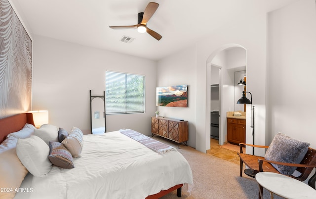 bedroom featuring connected bathroom and ceiling fan