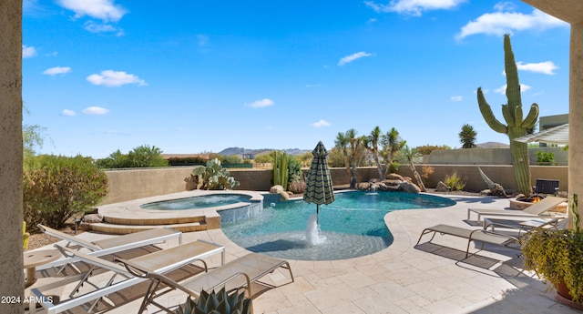 view of swimming pool featuring pool water feature, an in ground hot tub, and a patio