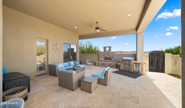 view of patio / terrace with an outdoor living space with a fireplace, area for grilling, and ceiling fan