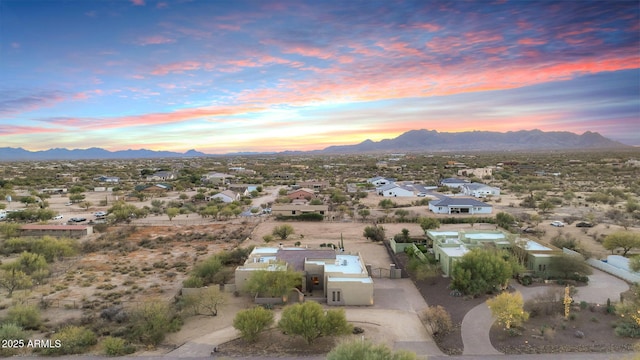 aerial view at dusk featuring a mountain view