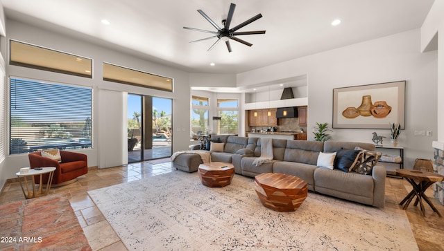 living room with a wealth of natural light and ceiling fan