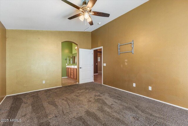 45131 W Horse Mesa Rd, Maricopa, AZ 85139 - spare room featuring arched walkways, a ceiling fan, and carpet flooring